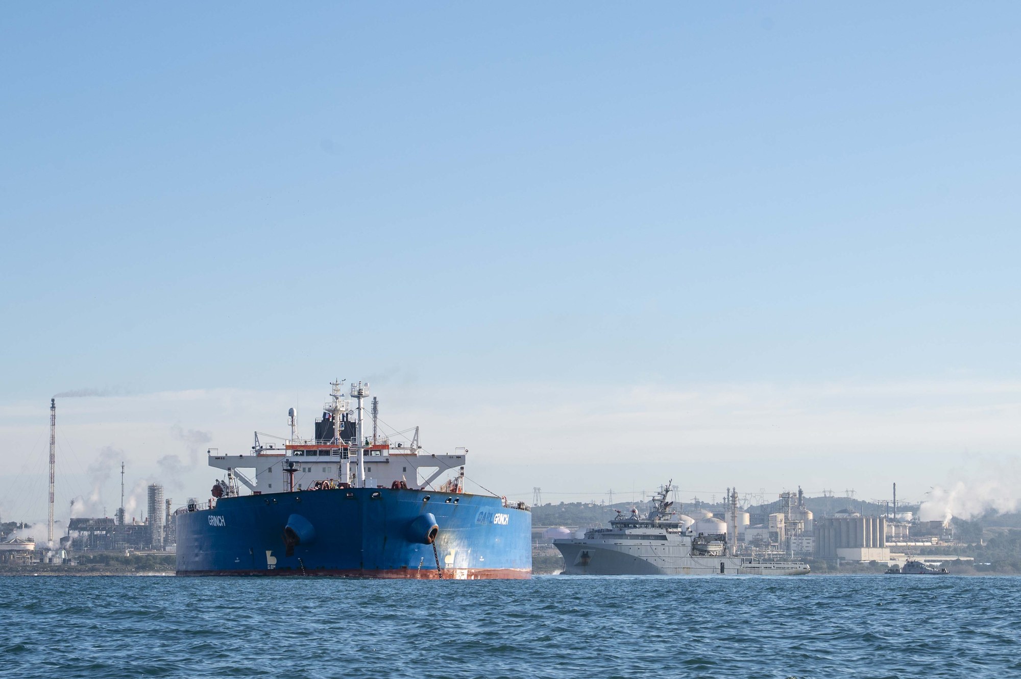 Grinch (IMO 9288851), name in frame, with a French Navy ship.