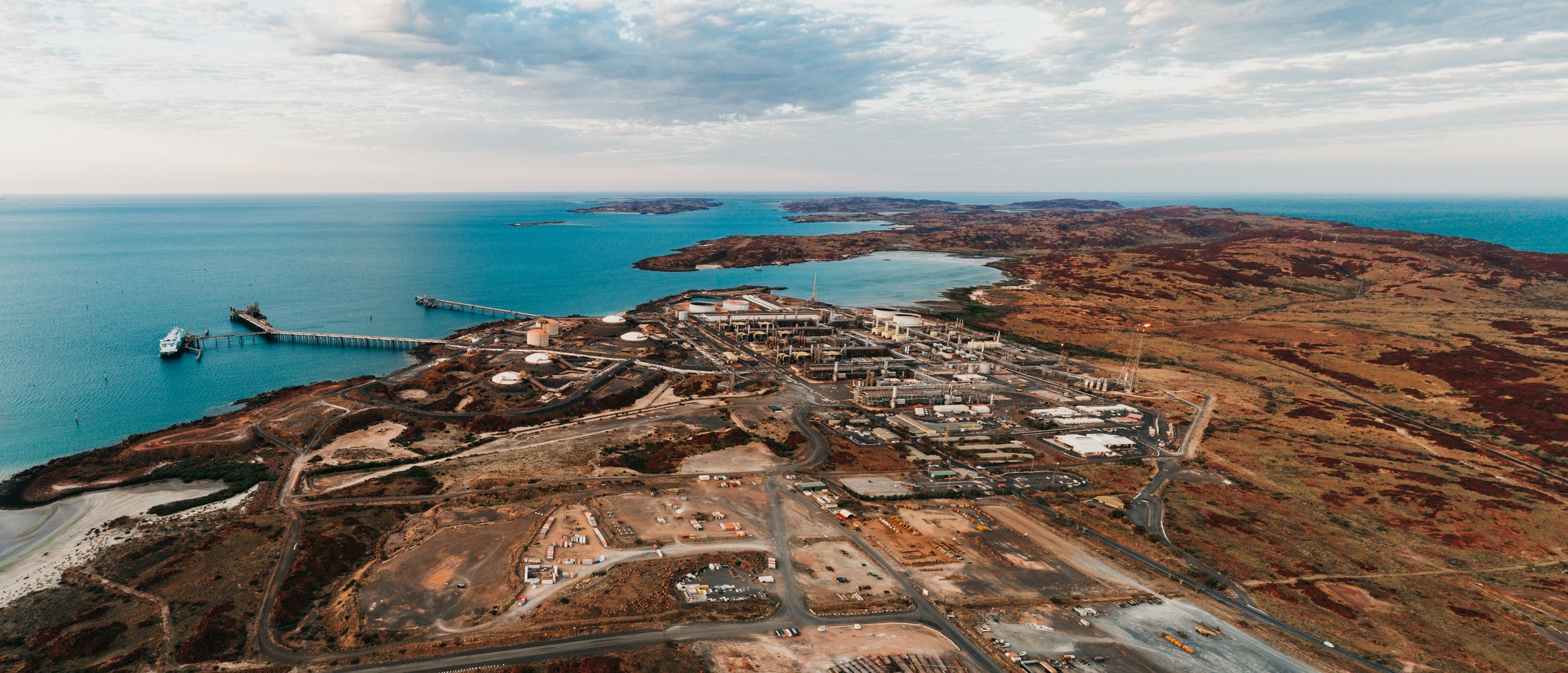 Aerial. Karratha Gas Plant on the Burrup, jetty, an LNG-type hull alongside.